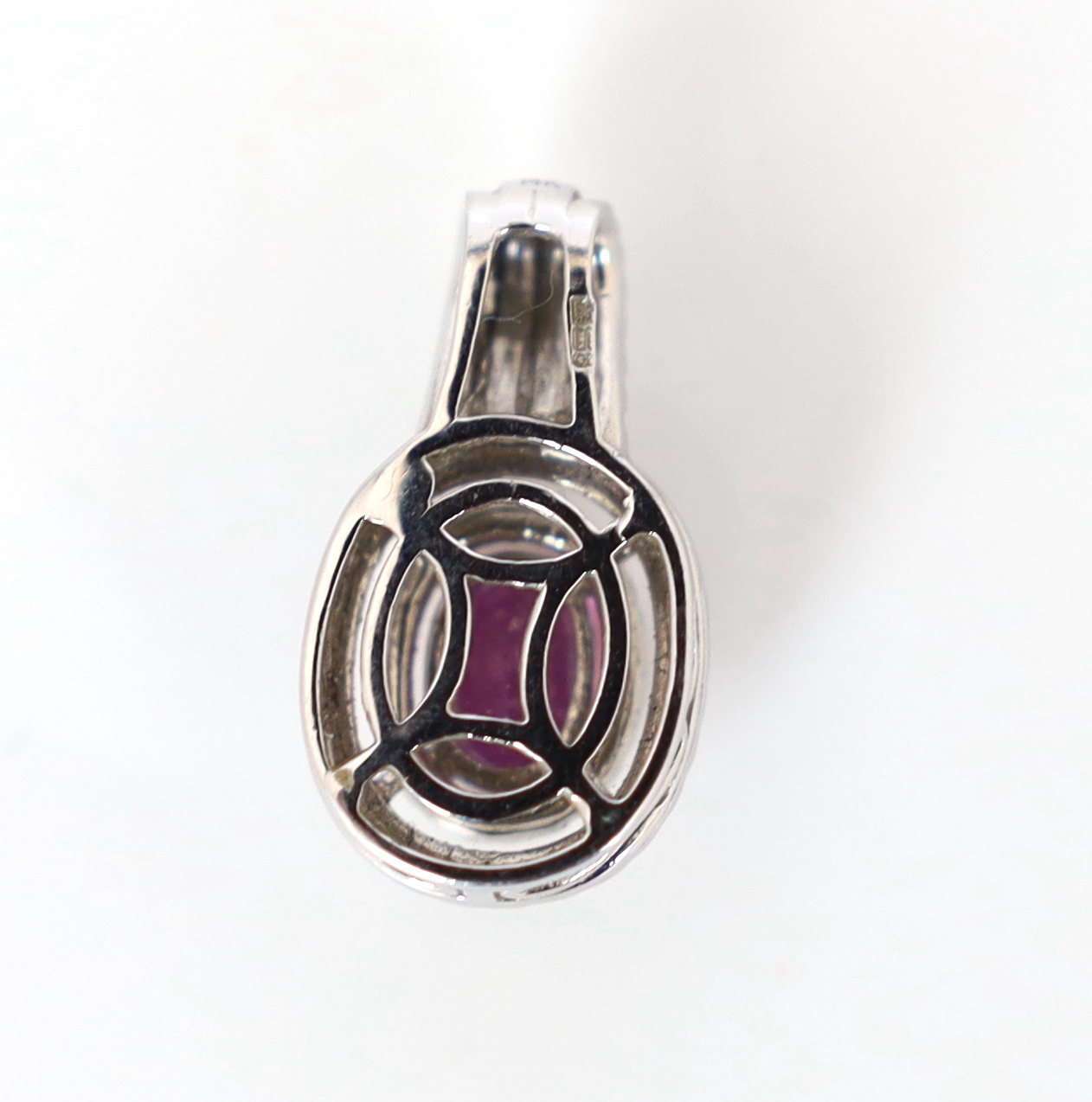 A modern 14ct white gold, pink sapphire and diamond set oval cluster pendant